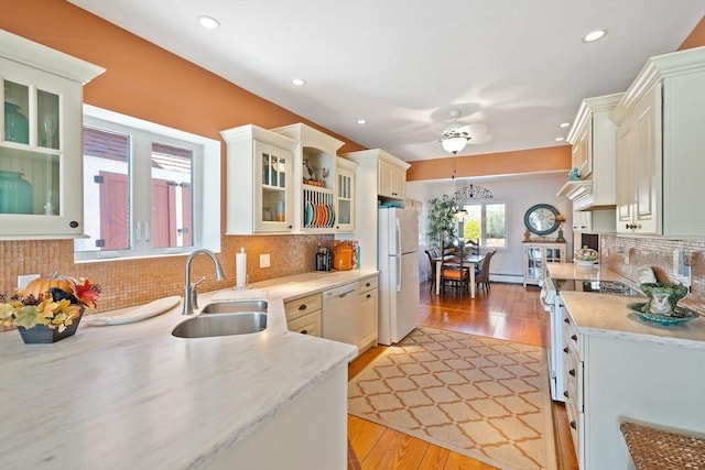 kitchen with recessed lighting, white appliances, ceiling fan, a sink, and light wood-type flooring