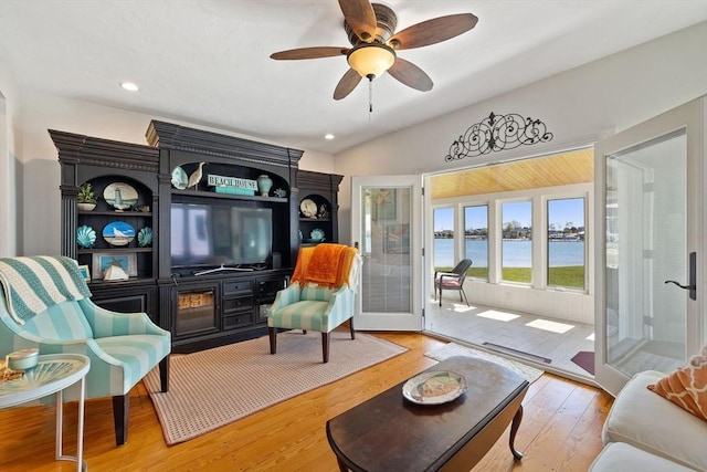 living room featuring wood finished floors, a ceiling fan, lofted ceiling, and recessed lighting