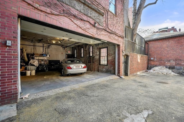 exterior space with brick siding and a garage