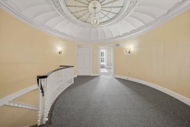 empty room featuring crown molding, baseboards, visible vents, and carpet floors