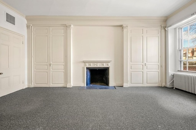 unfurnished living room with radiator, visible vents, a fireplace with flush hearth, ornamental molding, and carpet flooring