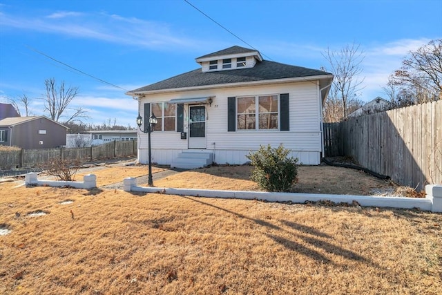 bungalow-style house with a front lawn