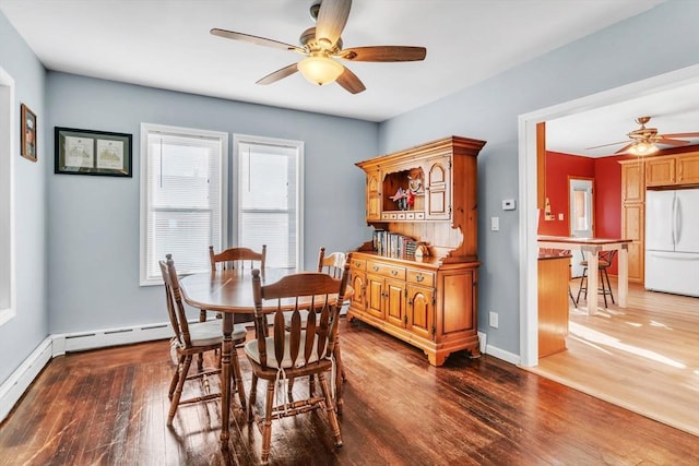 dining space featuring ceiling fan and dark hardwood / wood-style flooring