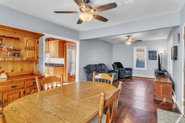 dining room featuring dark wood-type flooring, a baseboard radiator, and ceiling fan