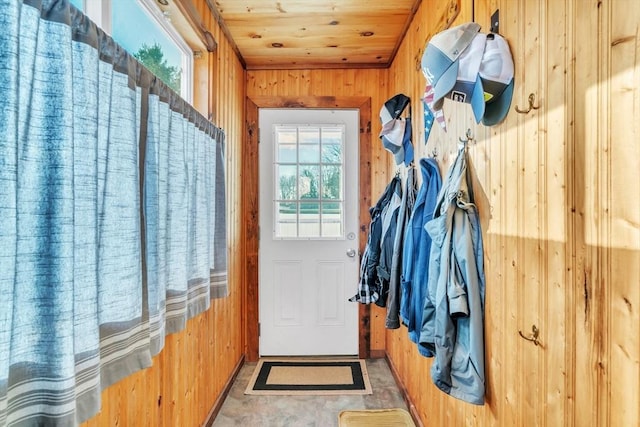 mudroom with wood ceiling and wood walls