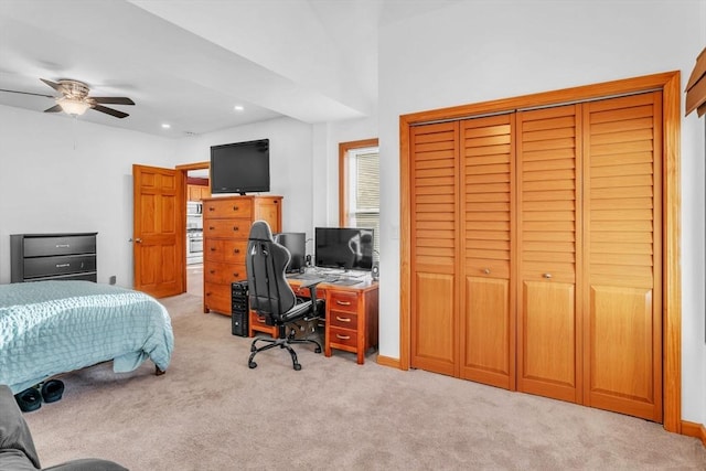 carpeted bedroom featuring ceiling fan and a closet