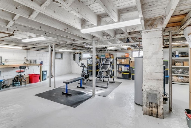 exercise area featuring gas water heater and electric panel