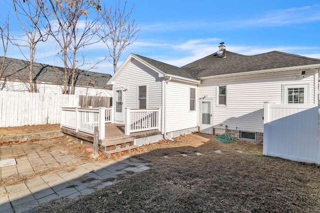 back of house with a wooden deck