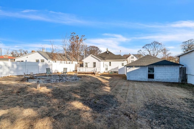 back of house featuring a wooden deck and a lawn