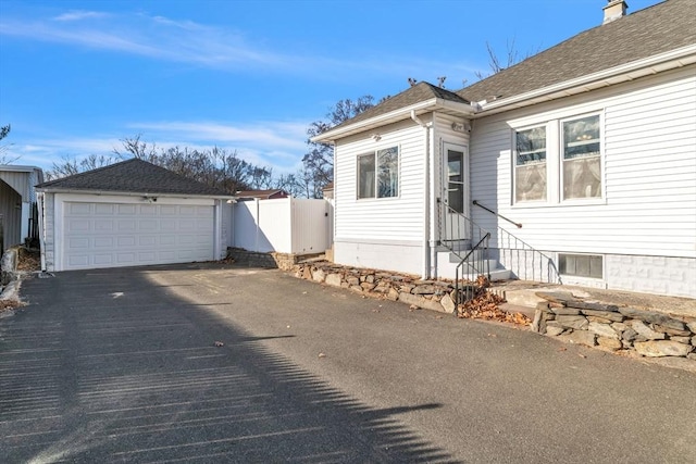 view of front of property with a garage and an outdoor structure