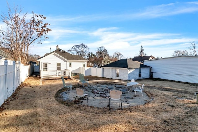 rear view of property featuring a wooden deck