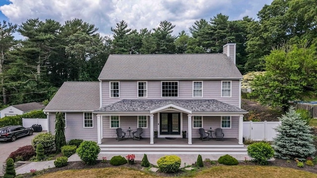 489 Main St, Acushnet, MA 02743 - view of front facade with french doors, a chimney, and a shingled roof