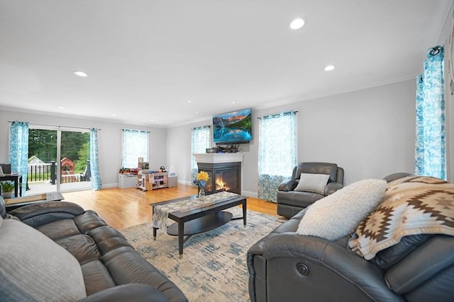 489 Main St, Acushnet, MA 02743 - living room featuring a glass covered fireplace, recessed lighting, wood finished floors, and ornamental molding