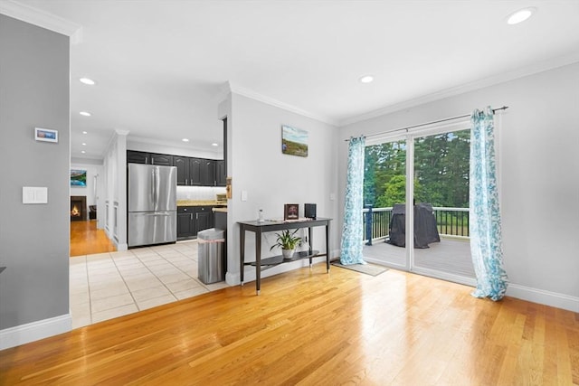 489 Main St, Acushnet, MA 02743 - living area featuring a lit fireplace, light wood-style floors, ornamental molding, and recessed lighting