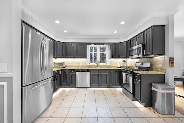489 Main St, Acushnet, MA 02743 - kitchen with appliances with stainless steel finishes, crown molding, tasteful backsplash, light tile patterned floors, and recessed lighting