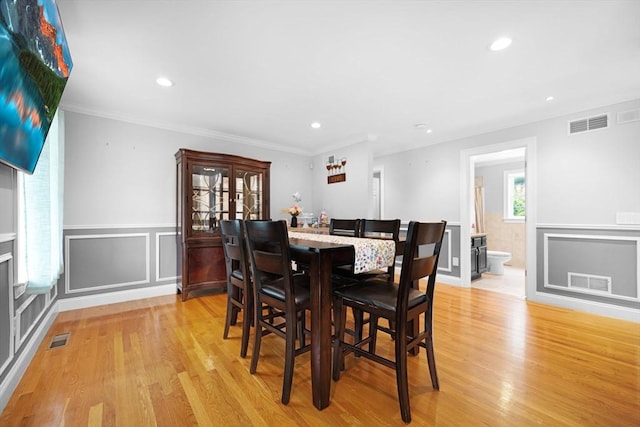 489 Main St, Acushnet, MA 02743 - dining area featuring light wood finished floors, a wainscoted wall, recessed lighting, a decorative wall, and crown molding