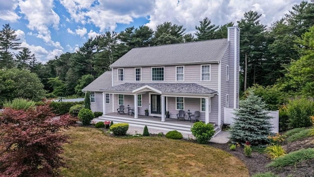 489 Main St, Acushnet, MA 02743 - view of front of house featuring a chimney, covered porch, a front lawn, and roof with shingles