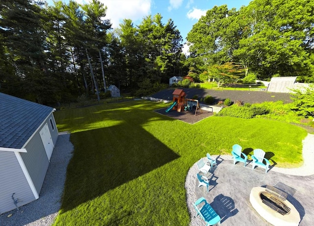 489 Main St, Acushnet, MA 02743 - view of grassy yard with a playground, view of wooded area, and a patio area