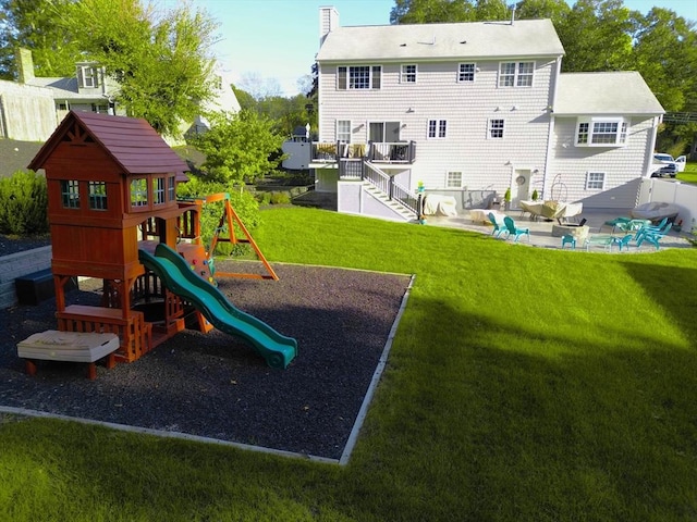 489 Main St, Acushnet, MA 02743 - back of house with a chimney, a playground, and a yard
