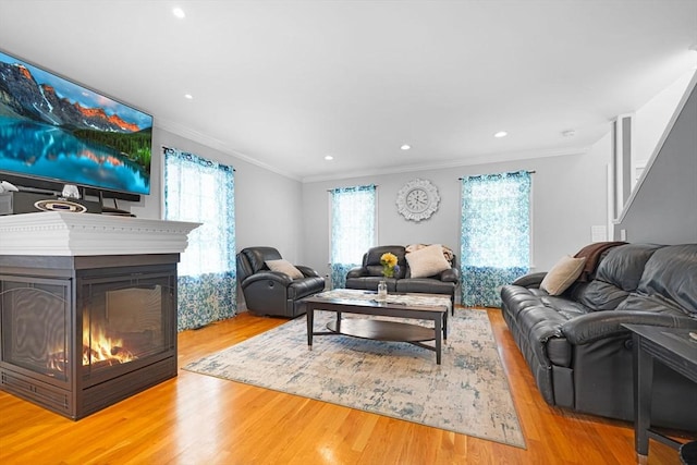 489 Main St, Acushnet, MA 02743 - living area with ornamental molding, wood finished floors, recessed lighting, and a glass covered fireplace