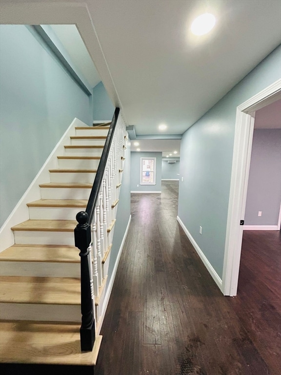 stairs with hardwood / wood-style floors