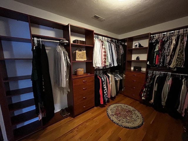 spacious closet with light hardwood / wood-style floors