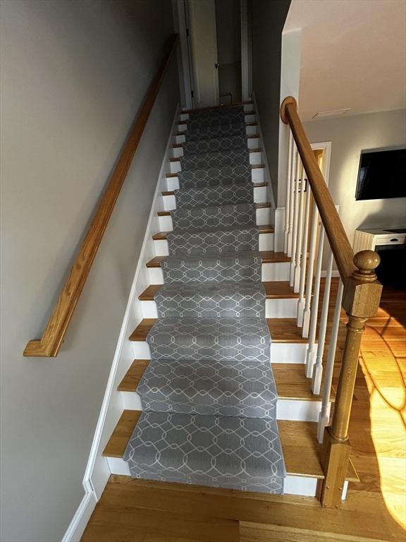 stairway with wood-type flooring