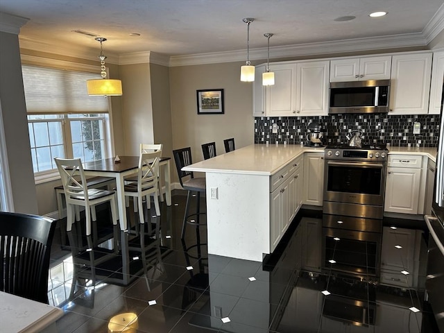 kitchen with stainless steel appliances, hanging light fixtures, a breakfast bar, and white cabinets