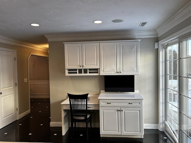 office area with crown molding and built in desk