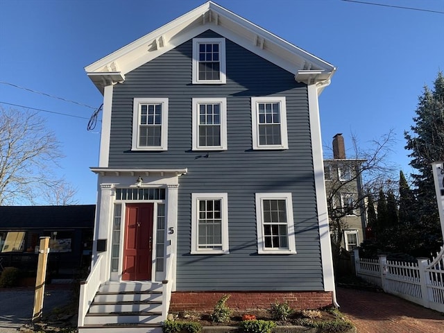 view of front of house with entry steps and fence