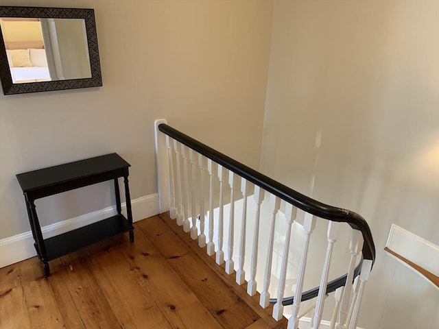 stairs with baseboards and hardwood / wood-style floors