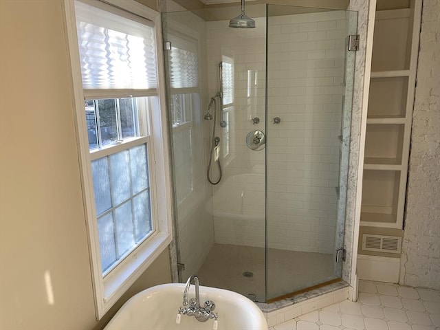 full bathroom with a stall shower, visible vents, and a soaking tub