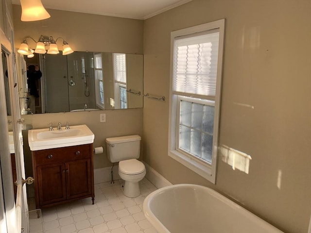 full bathroom with a freestanding bath, toilet, an enclosed shower, vanity, and baseboards