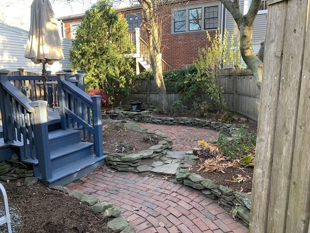 view of yard featuring fence and a patio