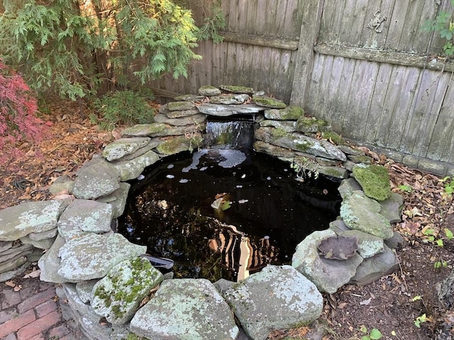 details with a small pond and fence