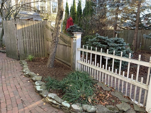 view of gate featuring a fenced backyard