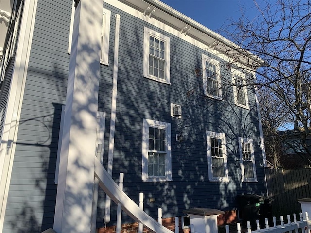 view of side of home featuring fence