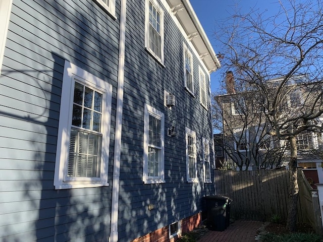 view of home's exterior with fence