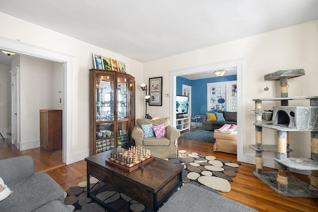 living area featuring baseboards and wood finished floors