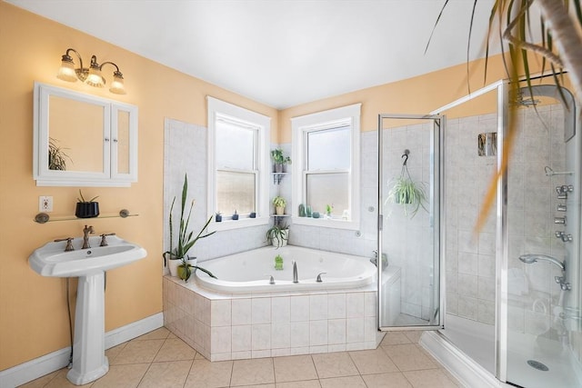 bathroom with a garden tub, a sink, a shower stall, and tile patterned floors