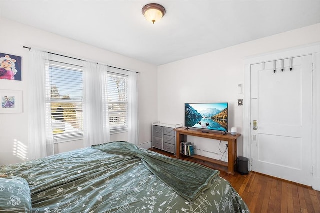 bedroom with dark wood finished floors