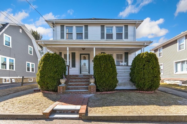 traditional style home featuring covered porch