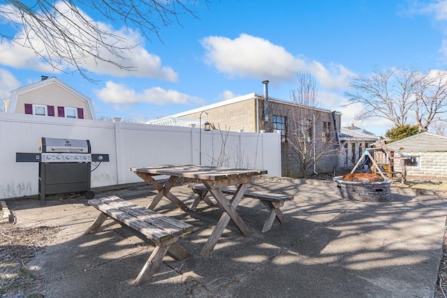 view of patio / terrace featuring an outdoor fire pit, fence, area for grilling, and outdoor dining space