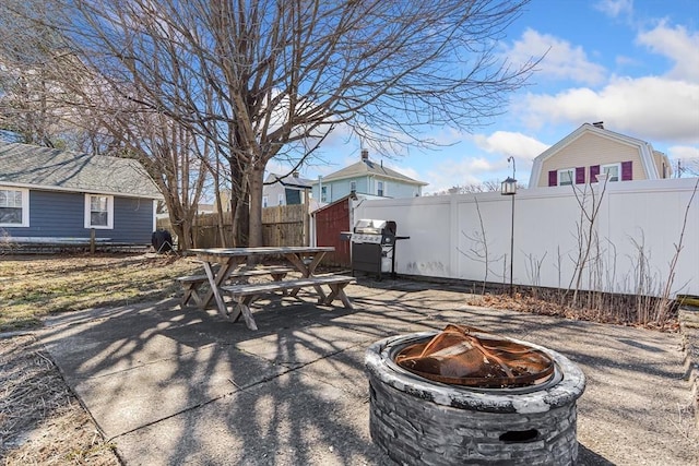 view of patio / terrace with a fire pit, outdoor dining area, area for grilling, and fence private yard