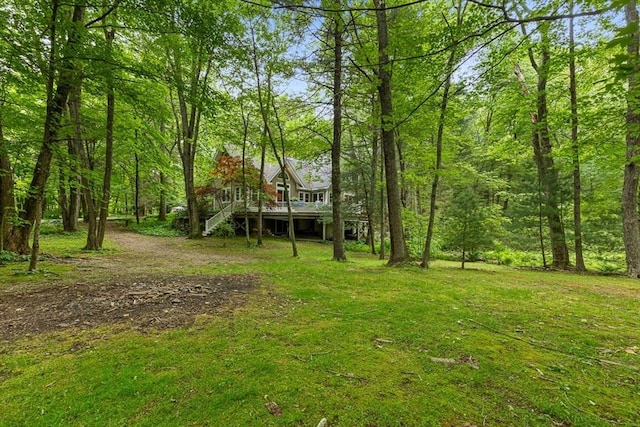 213 N Worcester St, Norton, MA 02766 - view of grassy yard with a wooden deck, stairway, and a wooded view