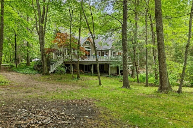 213 N Worcester St, Norton, MA 02766 - view of front facade featuring a deck, stairs, and a view of trees