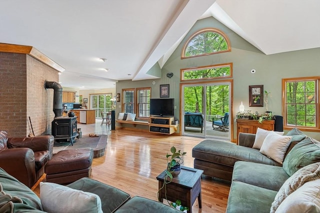 213 N Worcester St, Norton, MA 02766 - living area with a wood stove, light wood finished floors, and high vaulted ceiling