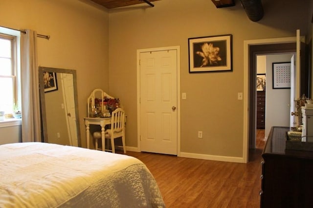 bedroom featuring baseboards and wood finished floors