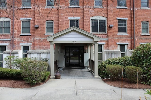 property entrance featuring brick siding