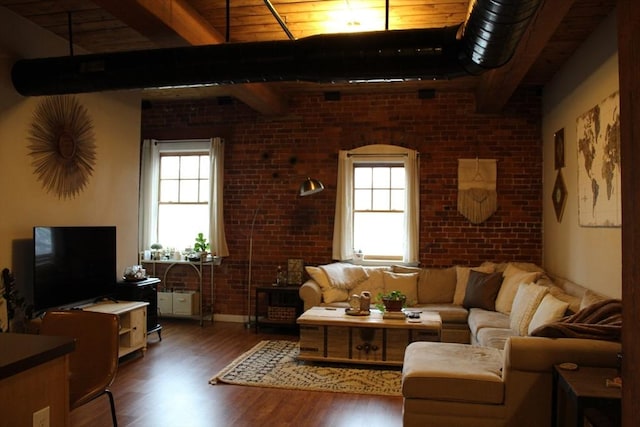 living room with beamed ceiling, plenty of natural light, and wood finished floors